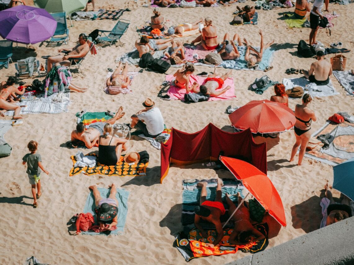 photo of people sunbathing on a beach
