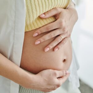 pregnant woman holding her baby bump