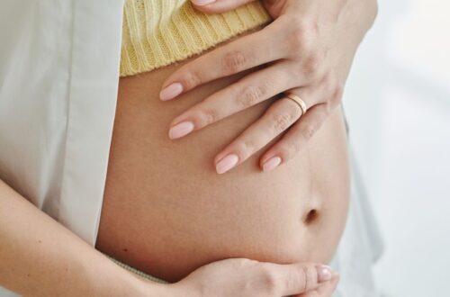 pregnant woman holding her baby bump