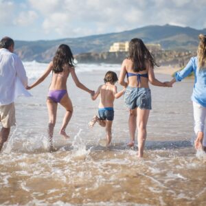 a family having fun on the shore with water