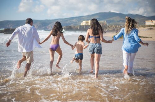 a family having fun on the shore with water