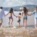 a family having fun on the shore with water